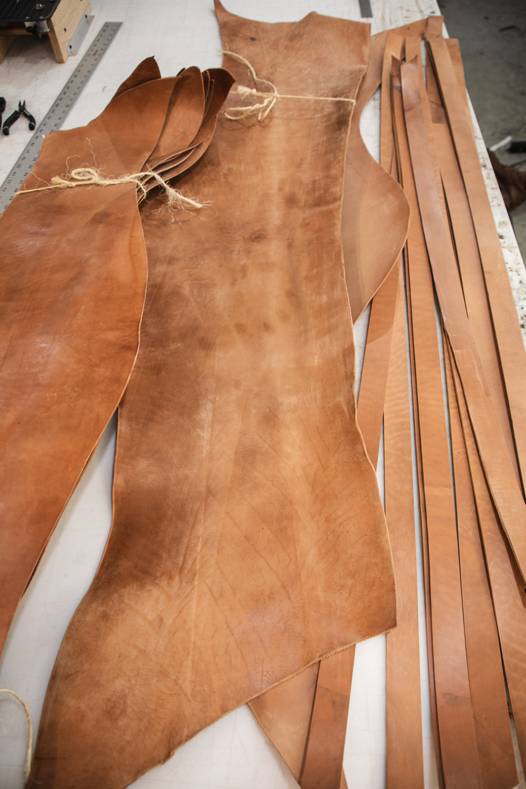 Russet horsehide belt strips on table