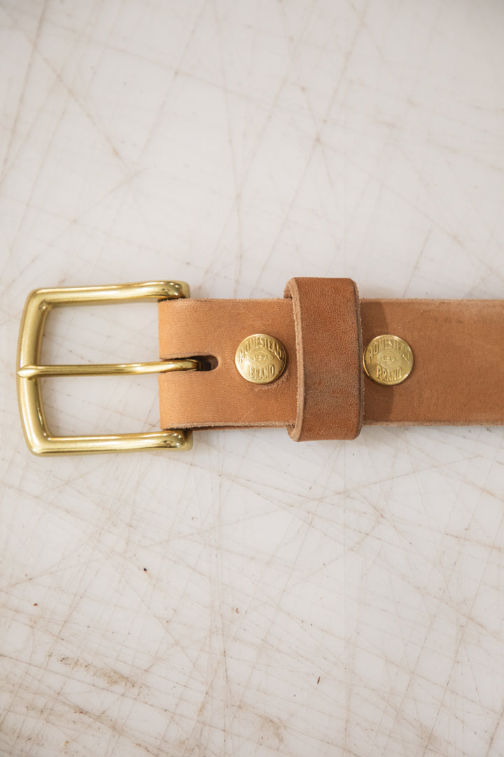 Russet horsehide belt buckle on table