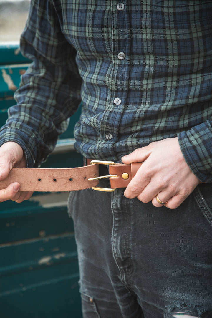 belt being fastened #color_brown