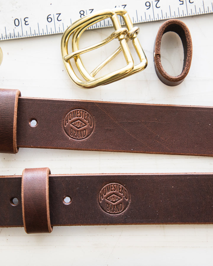 Essential belt brown Latigo 2 belts on table #color_brown