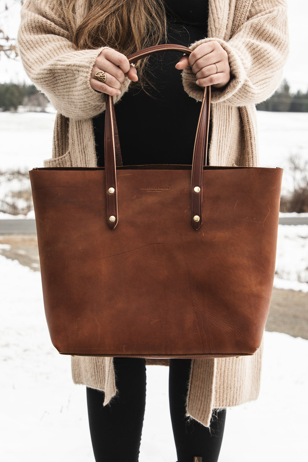 Classic Tote Brown Creative Holding Bag Front Shot Chest Down Close Up #color_brown