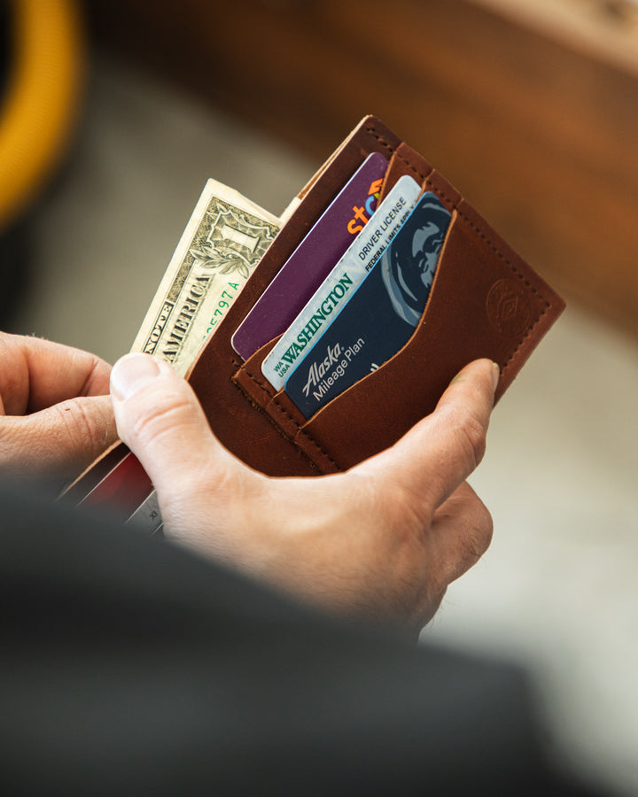 Essential 7 pocket bifold bills entering wallet