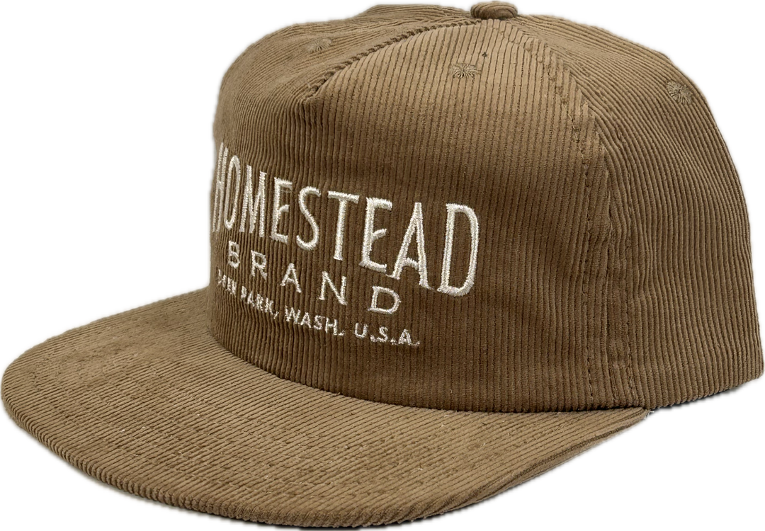 Side view of tan baseball cap on white background 