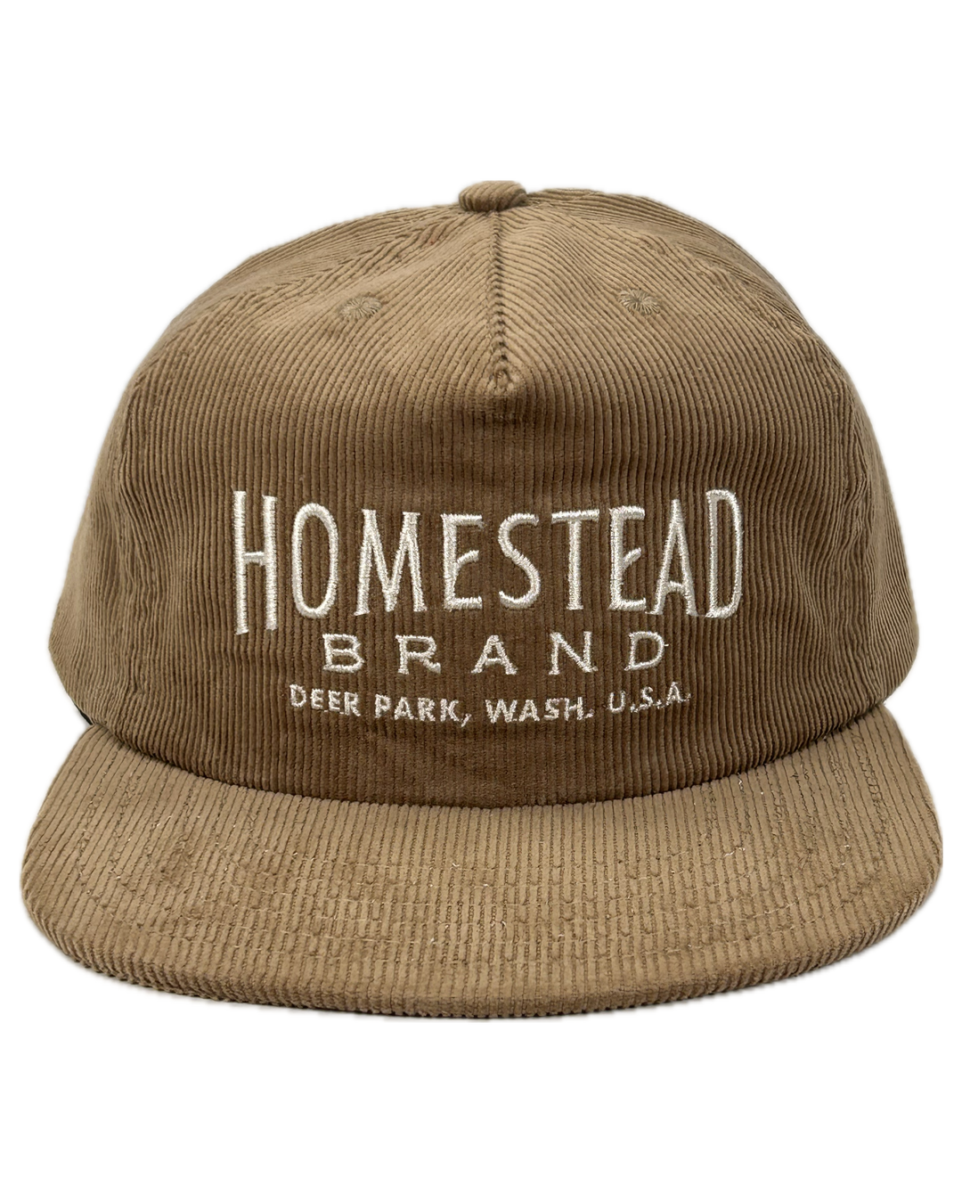 Tan colored baseball hat with “homestead brand deer park wash.” Embroidered on the front on top of a white background