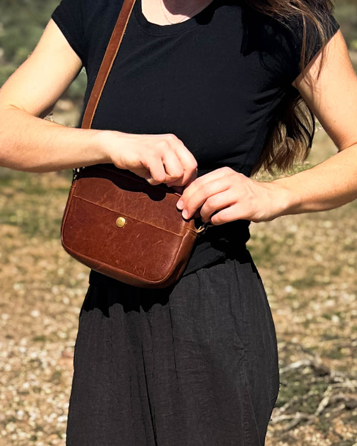 woman carrying crossbody bag close #color_brown