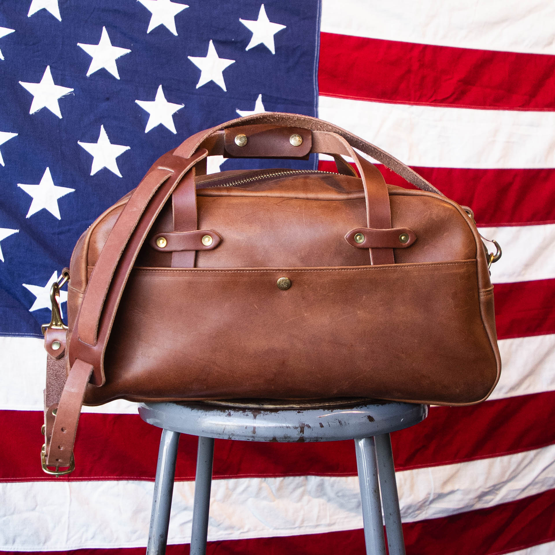 USA MADE Brown Duffle Bag in front of flag #color_brown