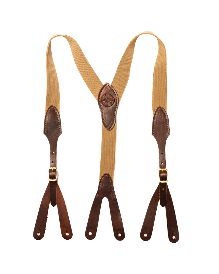 Tan suspenders with brown leather straps on a white background