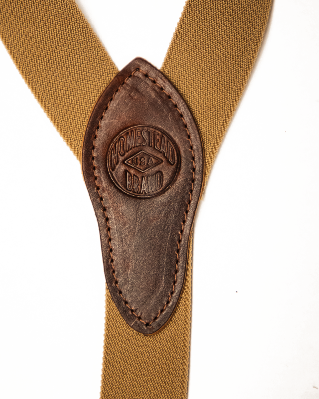 Brown suspenders with leather strap featuring &