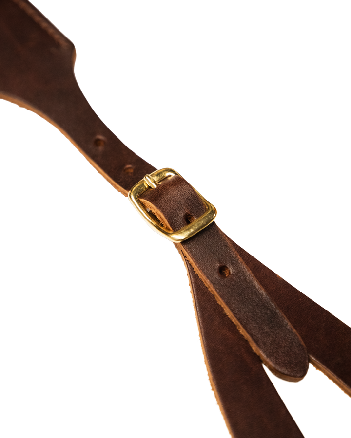 Brown leather strap with a gold buckle on a white background